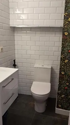 a white bathroom with a toilet and a sink at Casa Loma Manolo in Molinaseca