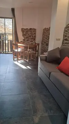 a living room with a couch and a table and chairs at Casa Loma Manolo in Molinaseca