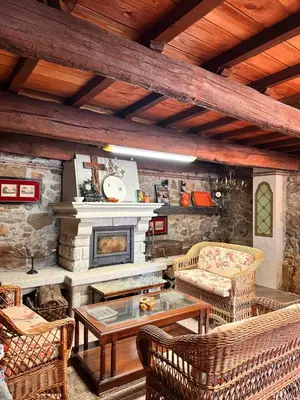 a living room with a couch and a fireplace at Casa do Cabo - 3 habitaciones con 3 baños independientes