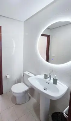 a kitchen with a microwave on a counter with a window at Casa Buen Camino in Arzúa