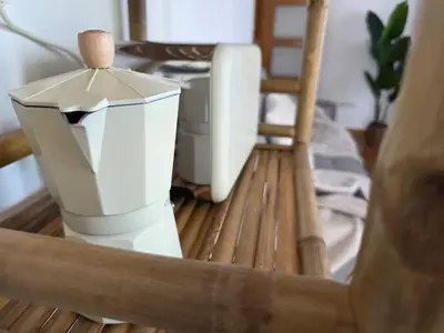 a white blender sitting on top of a wooden table at Costa Foz Apartment Playa de Llas, terraza, piscina y pista de pádel in Foz