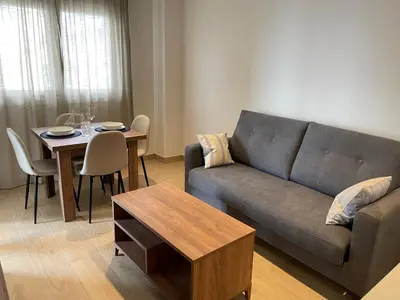 a living room with a couch and a table at As Tres Praias in Burela de Cabo