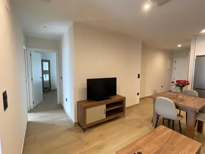 a living room with a television and a table at As Tres Praias in Burela de Cabo