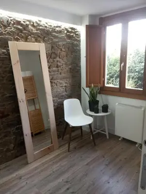 a room with a table and a chair and a mirror at Adiva Casa Da Avoa in Puentedeume