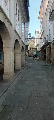 an empty street in a city with buildings at Adiva Casa Da Avoa in Puentedeume