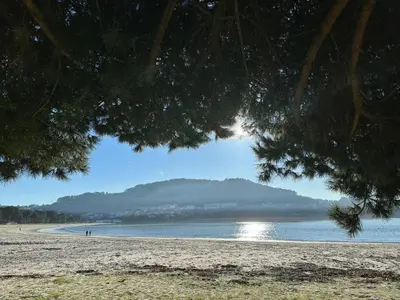 a view of a beach with a mountain in the background at Adiva Casa Da Avoa in Puentedeume