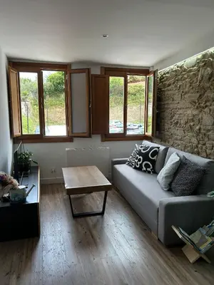 a living room with a couch and a table at Adiva Casa Da Avoa in Puentedeume