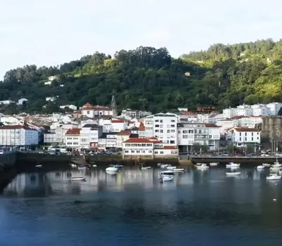 a city with boats in the water and a bridge at Adiva Loft in Puentedeume