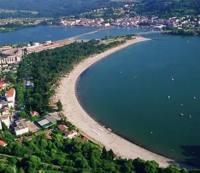an aerial view of a beach with boats in the water at Adiva Loft in Puentedeume