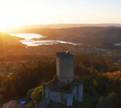 an aerial view of a castle with the sunset in the background at Adiva Loft in Puentedeume