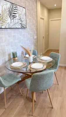 a dining room with a wooden table and chairs at Carude 76 in Monforte de Lemos