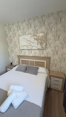 a bedroom with a bed with two towels on it at Carude 76 in Monforte de Lemos