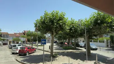 a street with cars parked in a parking lot at Carude 76 in Monforte de Lemos