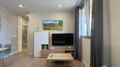 a living room with a television and a table at Carude 76 in Monforte de Lemos