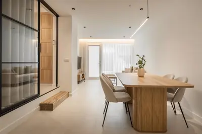 a dining room with a wooden table and chairs at Loft América 41 B in Melide