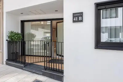 a sign on the side of a building that reads embassy at Loft América 41 B in Melide