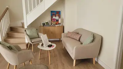 a living room with two chairs and a couch at Egeria Casa Jardín in Caldas de Reis