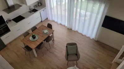 a kitchen and dining room with a table and chairs at Egeria Casa Jardín in Caldas de Reis