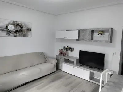 a living room with a couch and a table at Vivienda Turística Mou in Arzúa