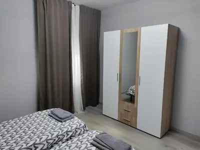 a bedroom with a bed and a dresser and a mirror at Vivienda Turística Mou in Arzúa