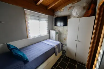 a small bedroom with a bed and a window at Casa Barxelo con piscina en Monforte de Lemos in Monforte de Lemos