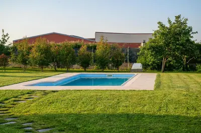 a swimming pool in the middle of a grass field at Casa Barxelo con piscina en Monforte de Lemos in Monforte de Lemos