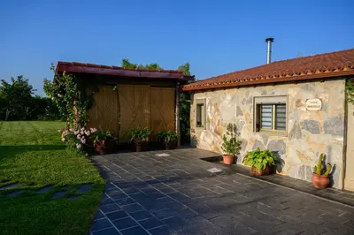 a house with a brick driveway next to a garage at Casa Barxelo con piscina en Monforte de Lemos in Monforte de Lemos