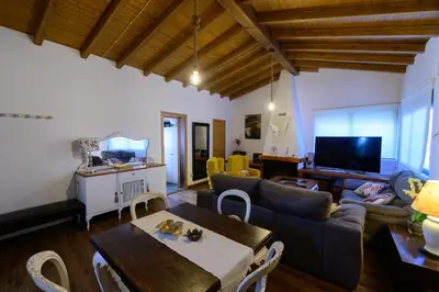 a living room with a couch and a table at Casa Barxelo con piscina en Monforte de Lemos in Monforte de Lemos