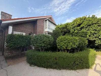 a brick house with trees and bushes in front of it at Casa Carlés by URent in Puentecesures
