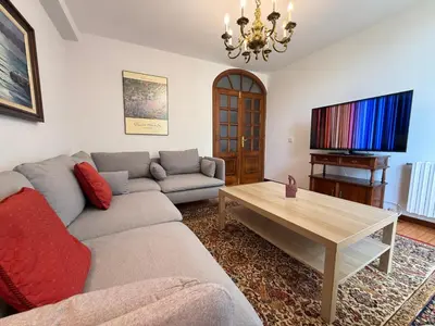 a living room with a couch and a table at Casa Carlés by URent in Puentecesures