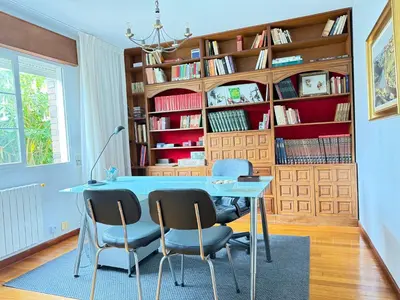 a dining room with a blue table and chairs at Casa Carlés by URent in Puentecesures