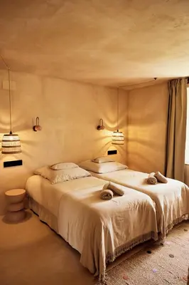 a bedroom with two beds and two lights on the wall at Casa Albaredo, Aldea Rural, Boutique Hotel, Retreat, in O Cebreiro
