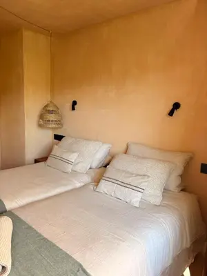 two beds sitting next to each other in a room at Casa Albaredo, Aldea Rural, Boutique Hotel, Retreat, in O Cebreiro