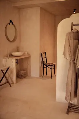 a bathroom with a sink and a mirror and a chair at Casa Albaredo, Aldea Rural, Boutique Hotel, Retreat, in O Cebreiro
