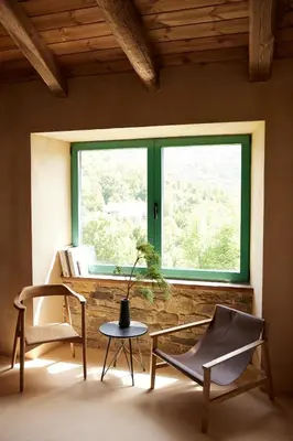 a room with two chairs and a table and a window at Casa Albaredo, Aldea Rural, Boutique Hotel, Retreat, in O Cebreiro