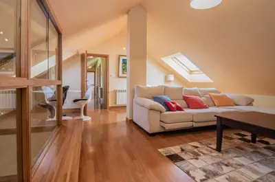 a living room with a white couch with pillows on it at Gavian House in A Coruña