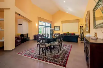 a dining room with a table and chairs in a living room at Gavian House in A Coruña