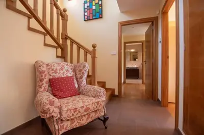 a living room with a chair and a staircase at Gavian House in A Coruña