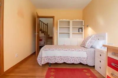 a bedroom with a bed and a mirror and a staircase at Gavian House in A Coruña