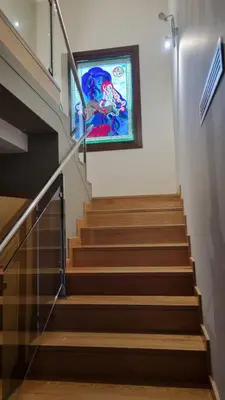 a staircase with a stained glass window in a building at A Casa de Chefa in San Ciprián