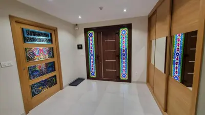 a hallway with three doors with stained glass at A Casa de Chefa in San Ciprián