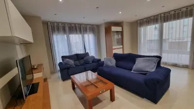 a living room with two blue couches and a table at A Casa de Chefa in San Ciprián