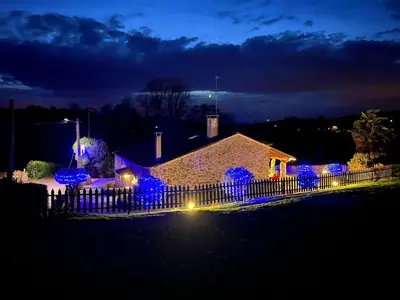 a house with blue lights on a fence at night at Casa Torres in Cruces