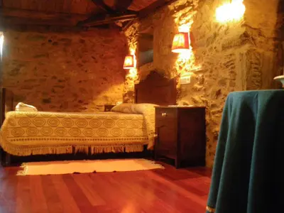 a bedroom with a bed in a stone wall at Casa Torres in Cruces