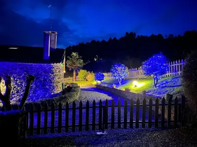 a fence in front of a house with blue lights at Casa Torres in Cruces