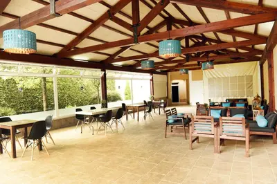 a large room with tables and chairs and windows at Hotel & Spa Carlos desde 1996 in Melide