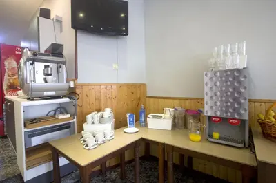 a counter with a basket of bread and a bread machine at Hotel & Spa Carlos desde 1996 in Melide