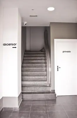 a staircase in a building with two doors and a hallway at Lux Apartamentos Santiago in Santiago de Compostela