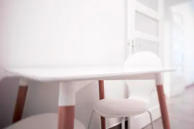 a white table with two chairs and a white stool at Lux Apartamentos Santiago in Santiago de Compostela