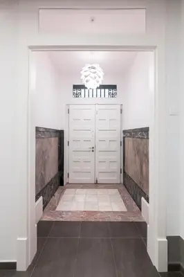 a garage with a white door and a chandelier at Lux Apartamentos Santiago in Santiago de Compostela